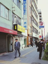 Full length of man standing on street in city