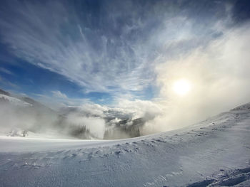 Scenic view of snow covered mountains against sky