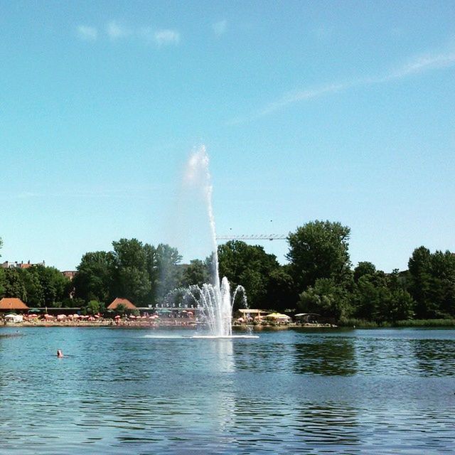 water, tree, waterfront, fountain, motion, sky, spraying, blue, scenics, splashing, beauty in nature, nature, long exposure, lake, flowing water, reflection, waterfall, river, outdoors, tranquility