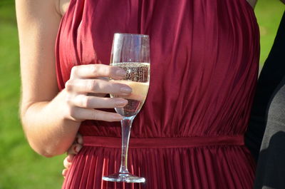 Midsection of a woman drinking glass