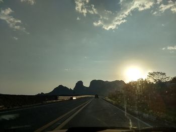 Road against sky seen through car windshield