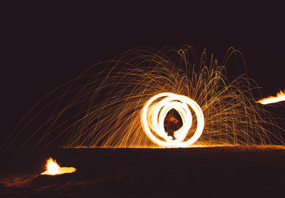 Low angle view of illuminated fire against sky at night