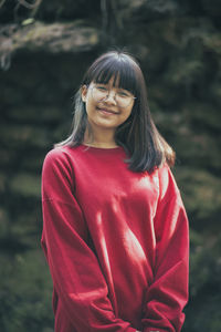 Portrait of smiling woman standing outdoors