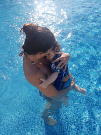 High angle view of mother and son in swimming pool