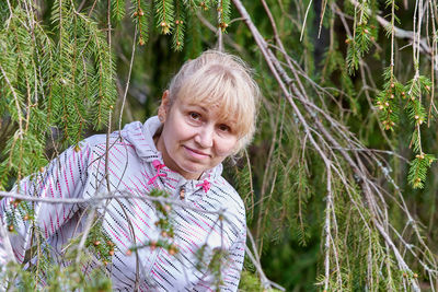 Portrait of woman against plants