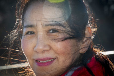 Close-up portrait of smiling young woman