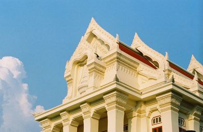 Low angle view of historic building against blue sky