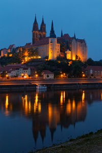 Reflection of illuminated buildings in water at night