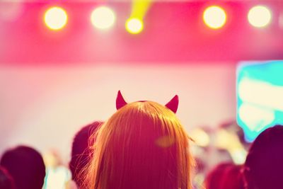 Rear view of woman with illuminated lights