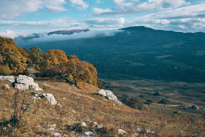 Scenic view of landscape and mountains against sky