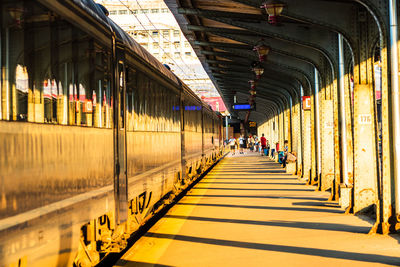 People waiting train at railroad station platform