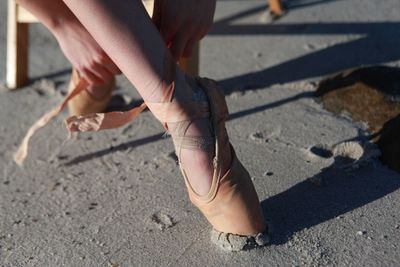 Low section of woman standing on tiled floor