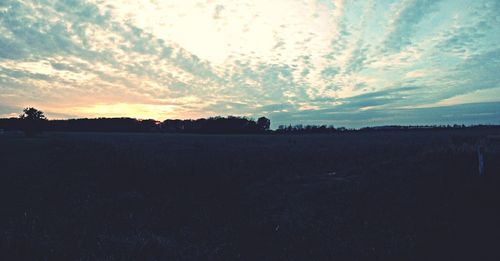 Scenic view of landscape against sky at sunset