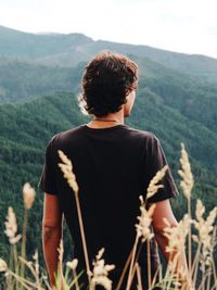 Rear view of man looking at mountains