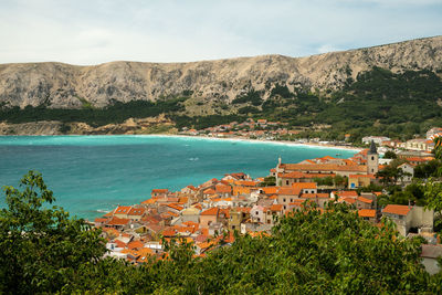 High angle view of townscape by sea