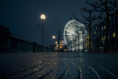 View of illuminated street lights at night