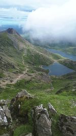 Scenic view of green mountains against sky