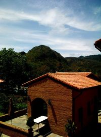 Houses in town against cloudy sky