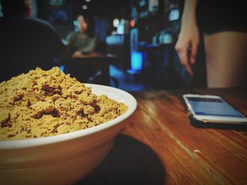 Close-up of man using laptop on table