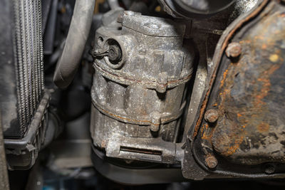 Air conditioning compressor in a passenger car seen from below.