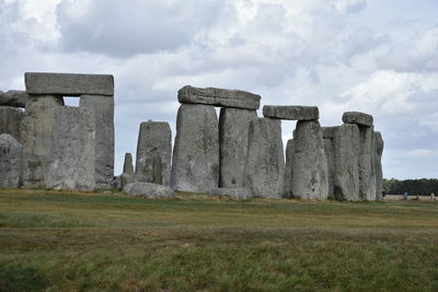 Built structure on field against cloudy sky