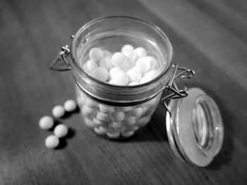 High angle view of ceramic balls in container on table