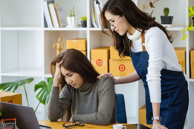 Side view of mother and daughter sitting at home