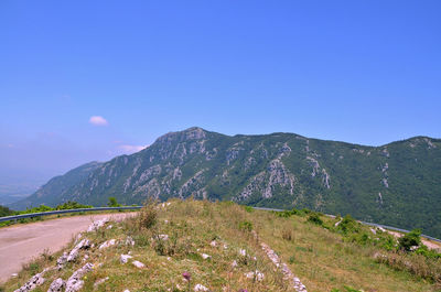 Scenic view of mountains against blue sky