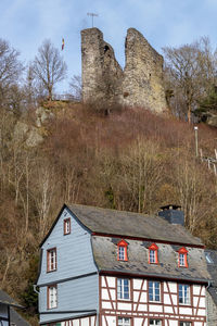 View at castle ruin haller and half-timbered house in monschau, germany