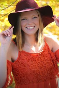 Portrait of smiling young woman in hat