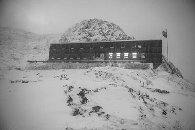 Built structure on snow against clear sky