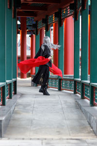 Side view of young woman standing in city