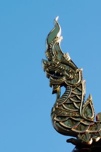 Low angle view of statue against blue sky