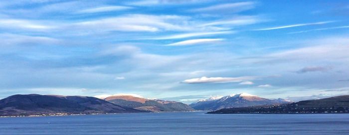 Scenic view of mountains against cloudy sky