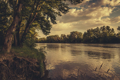 Scenic view of lake against cloudy sky