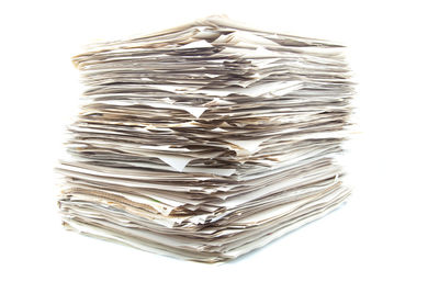 High angle view of stack on table against white background