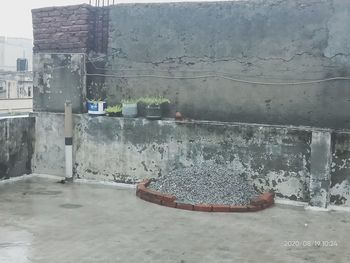 Abandoned building seen through wet glass wall