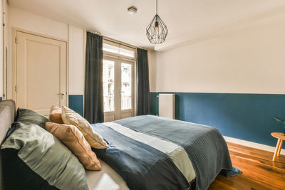 Low section of woman relaxing on bed at home