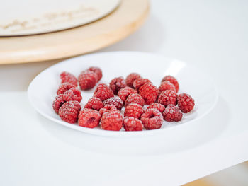 High angle view of strawberries in plate on table