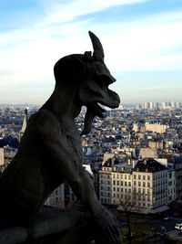 Statue of liberty against buildings in city