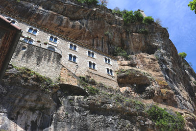 Low angle view of cliff against sky