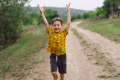 A six-year-old boy runs in the countryside.