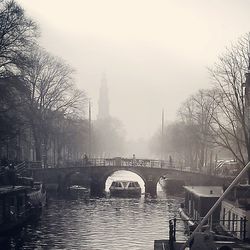 Boats in river with buildings in background