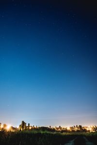 Scenic view of landscape against clear blue sky at night