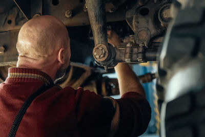 Rear view of man working in factory