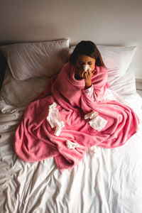 Woman relaxing on bed at home