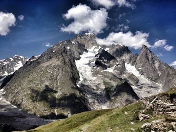 Scenic view of mountains against cloudy sky