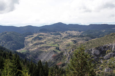 High angle view of trees on landscape against cloudy sky