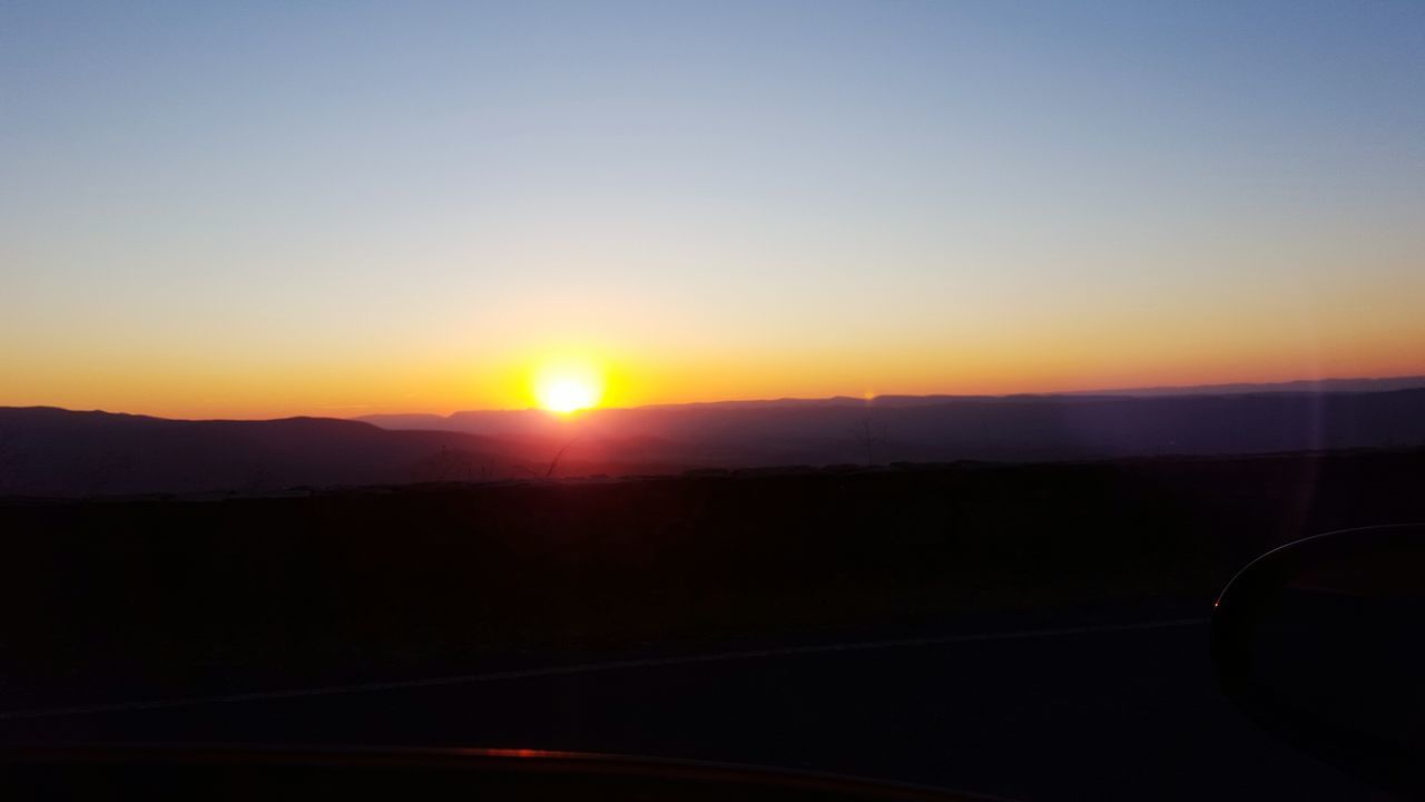 SILHOUETTE LANDSCAPE AGAINST SUNSET