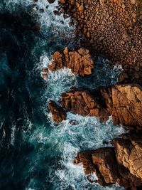 Directly above shot of rocks in sea